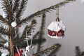 Christmas toy in the form of a red snow covered house hangs on the tree Royalty Free Stock Photo