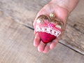 Christmas toy in the hands of a grandmother, an elderly man. New Year. Christmas. Wooden Background