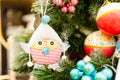 Christmas Toy hanging on branch Burning Candles, Boxes, Balls, Pine Cones, Walnuts, Branchesin the background other Royalty Free Stock Photo