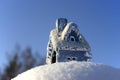 Christmas toy house on the snowdrift Royalty Free Stock Photo