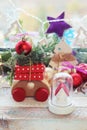 Christmas toy house, wooden car with gifts and a tree, New Year decorations, illumination, fir-tree branches on the background of Royalty Free Stock Photo