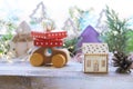 Christmas toy house, wooden car with gifts and a tree, New Year decorations, illumination, fir-tree branches on the background of Royalty Free Stock Photo