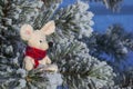 Christmas toy mouse, a symbol of the Chinese New Year. In a red knitted scarf. The concept of winter, warmth and comfort.