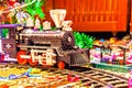 Christmas toy railroad near a Christmas tree with lights Royalty Free Stock Photo