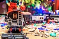 Christmas toy railroad near a Christmas tree with lights Royalty Free Stock Photo