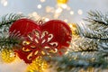 Christmas toy red heart with ornament. Pine branches on ice crystals. Background and bokeh. Toned image. Happy New year. Royalty Free Stock Photo