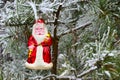 Christmas toy red Santa Claus on a natural branch with pine tree needles in the snow background. Concept for New Year, Christmas Royalty Free Stock Photo