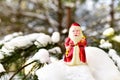 Christmas toy Santa Claus on branch with pine tree needles in the snow. Christmas balls decoration. oncept of preparing for the Royalty Free Stock Photo