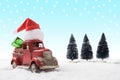 Christmas toy santa truck with gift boxes and pine tree on snow Royalty Free Stock Photo