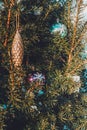 Christmas toy in the shape of a bump of golden color on a Christmas tree smothered by snow Royalty Free Stock Photo