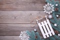 Christmas toy sledge with fir-tree branch on a grey background Royalty Free Stock Photo