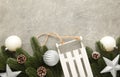 Christmas toy sledge with fir-tree branch on a grey concrete background Royalty Free Stock Photo