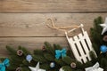 Christmas toy sledge with fir-tree branch on a grey wooden background Royalty Free Stock Photo