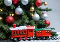 A Christmas Toy Train Under A Tree, With A Front Angle. Generative AI