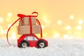 Christmas toy truck with gift boxes and pine tree on wooden table over green background Royalty Free Stock Photo
