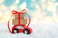 Christmas toy truck with gift boxes and pine tree on wooden table over green background Royalty Free Stock Photo