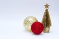 Christmas toy, two shiny balls of red and golden and golden tree. New Year. On a gray background Royalty Free Stock Photo