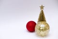 Christmas toy, two shiny balls of red and golden and golden tree. New Year. On a gray background Royalty Free Stock Photo