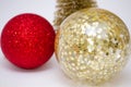 Christmas toy, two shiny balls of red and golden and golden tree. New Year. On a gray background Royalty Free Stock Photo