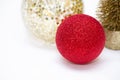 Christmas toy, two shiny balls of red and golden and golden tree. New Year. On a gray background Royalty Free Stock Photo