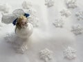 Christmas toy on white snowflakes background. Christmas angel. Royalty Free Stock Photo