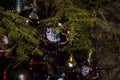 Christmas toys against the background of green branches and lights