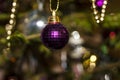 Christmas toys against the background of green branches and lights