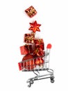 Christmas toys in the buyer`s basket. Full shopping cart. Balls, gifts, stars. White isolated background. The concept of gifts an Royalty Free Stock Photo