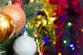 Christmas toys on the Christmas tree on the colorful lighting background. Beautiful glass Christmas decorations. Cool bright New Royalty Free Stock Photo