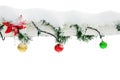 Christmas toys and garlands with pine branches on the old wooden fence covered with ice and icicles on a white background. Isolate Royalty Free Stock Photo