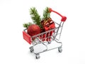 Christmas toys, gifts and spruce branch in the buyer`s basket. Full shopping cart. White isolated background. The concept of gift Royalty Free Stock Photo