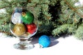 Christmas toys in a glass cup on a white background Royalty Free Stock Photo