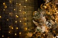 Christmas toys on the pine tree. Shiny balls, orange light bulbs. Dark background. Royalty Free Stock Photo