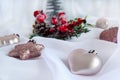 Christmas toys - pink shiny balls on a light background and a defocused foreground. New Year or Christmas card, invitation