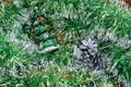 Christmas toys spruce and cones on a green tinsel