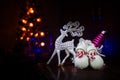 Christmas toys on table at decorative fir-tree blurred with lights. Making a Christmas tree on table. Empty space. Useful as greet Royalty Free Stock Photo