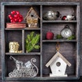 Christmas toys in a vintage wooden box: antique clocks, birdhouse, balls, ribbons and sleigh Santa House