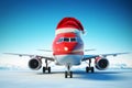 Christmas travel concept. An airplane wearing a red Father Christmas santa hat