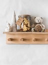 Christmas treats for Santa - cookies in a jar, Christmas decorations on a wooden shelf-hanger on the wall in a bright room