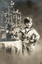 Christmas tree antique toys. Happy child with gifts Vintage picture