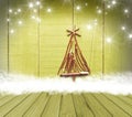 Christmas tree arranged from sticks on empty wooden deck table on sparkly green background. Ready for product display montage Royalty Free Stock Photo