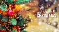 Christmas tree background and Christmas decorations with blurred, sparking, glowing and text Merry Christmas and Happy New Year. Royalty Free Stock Photo