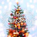 Christmas tree background and Christmas decorations with blurred, sparking, glowing and text Merry Christmas and Happy New Year.