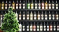 Christmas tree on the background of rows of liquor bottles in the bar. Royalty Free Stock Photo