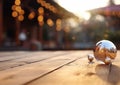 Christmas tree ball on wooden table with decorated vacation houses background.Macro.AI Generative Royalty Free Stock Photo