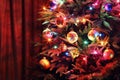 Christmas tree with balls, glowing garland and tinsel