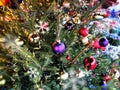 Christmas tree  balls and  Pine cones  on  Christmas tree fir branches red green blue colored decoration and white snowflakes  , Royalty Free Stock Photo