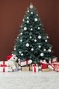 Christmas tree pine with gifts decor brown background 2021 2022