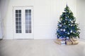 Christmas tree with blue in a white room with toys for Christmas Royalty Free Stock Photo