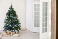 Christmas tree with blue in a white room with toys for Christmas Royalty Free Stock Photo